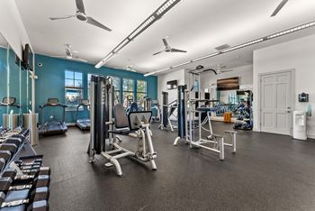 A spacious gym with a variety of equipment including treadmills, stationary bikes, and weight machines. at Bridge at Indigo, Texas, 78717
